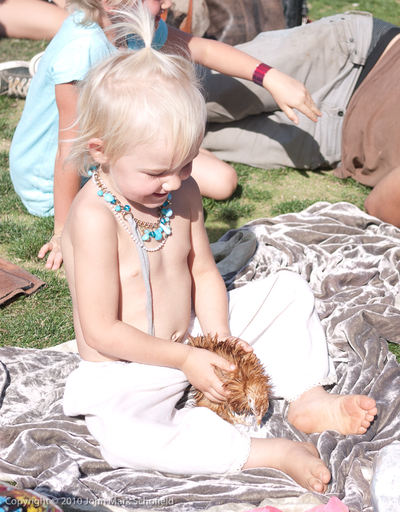 Happy hippy baby with a chicken
